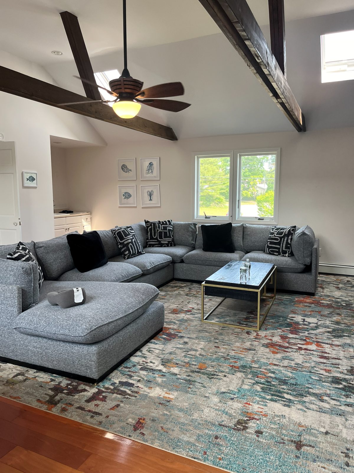 Freshly cleaned living room with vaulted ceiling and sectional sofa